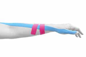 Idris is using Kinesio Taping on a patient's arm in his Notting Hill Studio