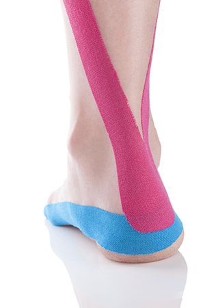 Idris is using Kinesio Taping on a foot in his Notting Hill Studio